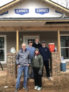 Team Standing in Front of Construction Project