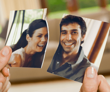 The image portrays two hands separating the fragments of a torn photograph, featuring portraits of two individuals.