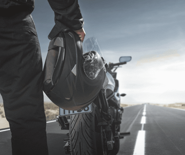 Man with a helmet and a motorcycle.