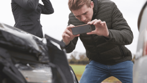 Man Documents Car Damage with Photo