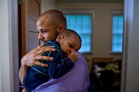 A father carrying his child.