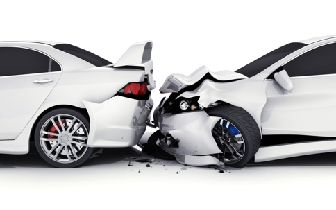 two white cars that have suffered a frontal collision.